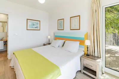 a bedroom with a large bed and a window at Beautiful Calheta Villa Villa Do Mar Iii 3 Bedrooms Infinity Pool in Arco da Calheta