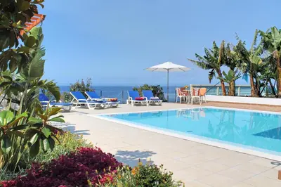 a swimming pool with a view of the ocean at Beautiful Calheta Villa Villa Do Mar Iii 3 Bedrooms Infinity Pool in Arco da Calheta