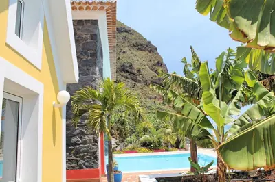 a villa with a swimming pool and palm trees at Beautiful Calheta Villa Villa Do Mar Iii 3 Bedrooms Infinity Pool in Arco da Calheta