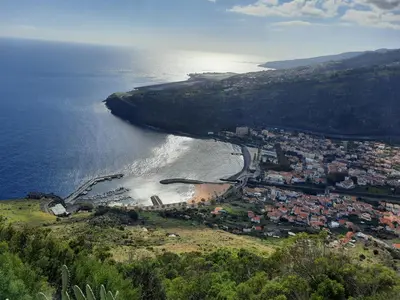 an aerial view of a town and a beach at Sunny Beach Machico Apartment by Holiday Rental Madeira in Machico