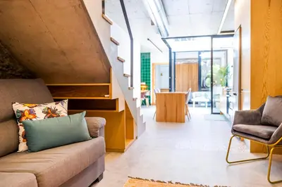 a living room with a couch and a chair at Casa Da Avo Clementina Nº32 in Funchal