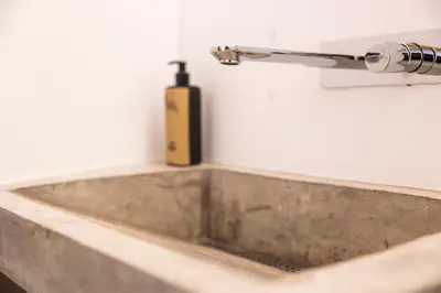 a bathroom sink with a soap dispenser on a wall at Casa Da Avo Clementina Nº32 in Funchal