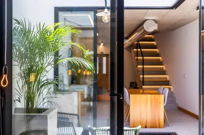 a room with a staircase and a table and chairs at Casa Da Avo Clementina Nº32 in Funchal