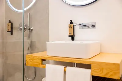 a bathroom with a white sink and a shower at Casa Da Avo Clementina Nº32 in Funchal