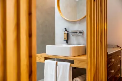 a bathroom with a white sink and a mirror at Casa Da Avo Clementina Nº32 in Funchal