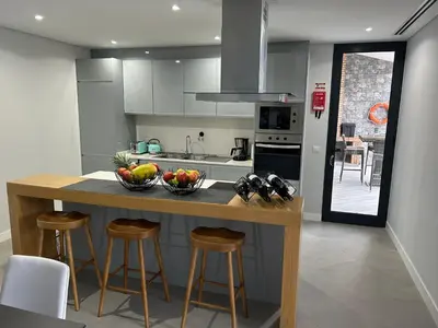 a kitchen with a counter with bowls of fruit on it at Villa Sol e Mar in Ribeira Brava