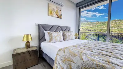 a bedroom with a bed and a large window at Villa Oceânica by LovelyStay in Ribeira Brava