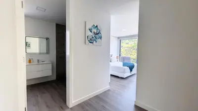 a white room with a bed and a mirror at Villa Oceânica by LovelyStay in Ribeira Brava