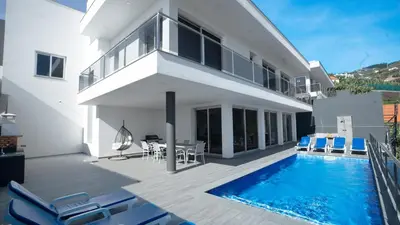 a villa with a swimming pool and a house at Villa Oceânica by LovelyStay in Ribeira Brava
