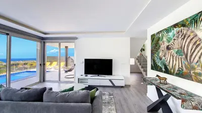 a living room with a couch and a tv at Villa Oceânica by LovelyStay in Ribeira Brava
