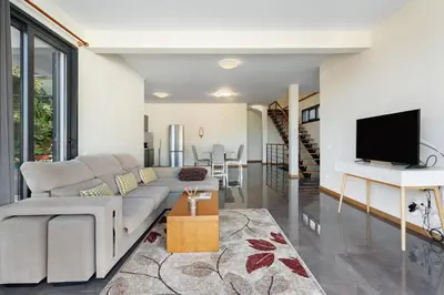 a living room with a couch and a tv at Casa da Pontinha in Machico