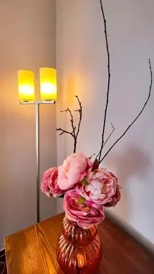 a vase filled with pink flowers on a table at Casa Gina, with views to Funchal Bay in Funchal