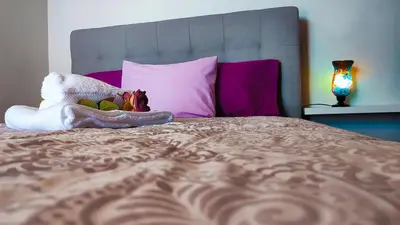 a stuffed animal sitting on top of a bed at Casa Gina, with views to Funchal Bay in Funchal