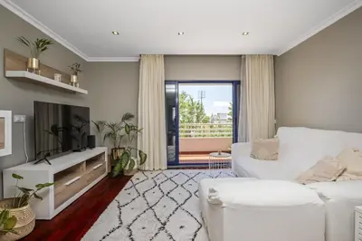a living room with a white couch and a tv at Barreiros Balcony in Funchal