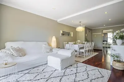 a living room with a white couch and a dining room at Barreiros Balcony in Funchal