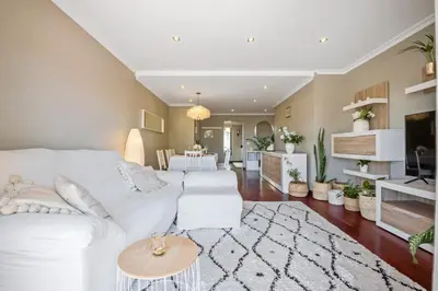 a living room with a white couch and a table at Barreiros Balcony in Funchal