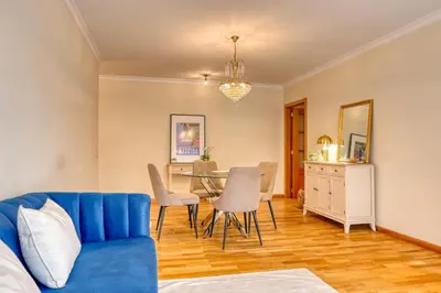 a living room with a blue couch and a table at Costa do Sol, a Home in Madeira in Funchal