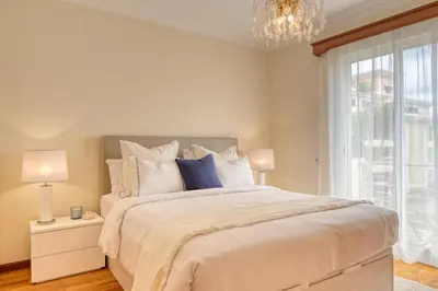a bedroom with a large bed and a window at Costa do Sol, a Home in Madeira in Funchal