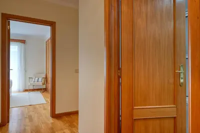 a room with a wooden door and a hallway at Costa do Sol, a Home in Madeira in Funchal