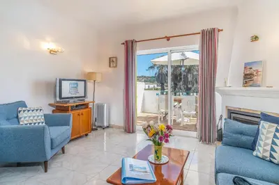 a living room with a fireplace and a tv at Casa Azure in Luz