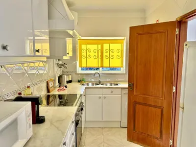 a kitchen with yellow cabinets and a sink at Casa Azure in Luz
