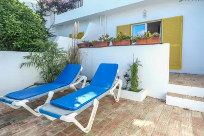 a pair of blue chairs on a patio at Casa Azure in Luz
