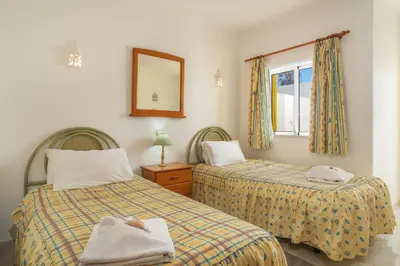 a hotel room with two beds and a window at Casa Azure in Luz