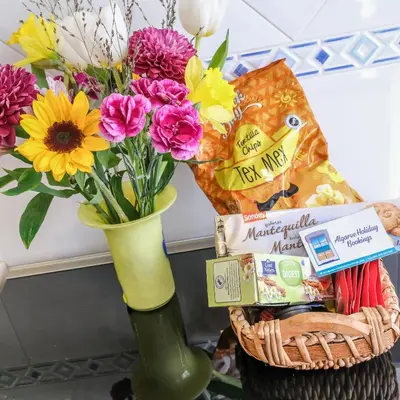 a vase filled with flowers next to a basket of chips at Casa Azure in Luz