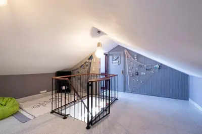 an attic room with a staircase and a wall at Terrace to Atlantic in Santa Cruz