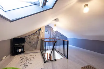 an attic room with a staircase with a skylight at Terrace to Atlantic in Santa Cruz