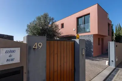 a house with a wooden gate in front of it at Elísio do Mar by LovelyStay in Prazeres