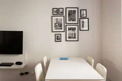 a white dining room with a white table and chairs at Casa Primavera - renovated duplex in city centre in Funchal