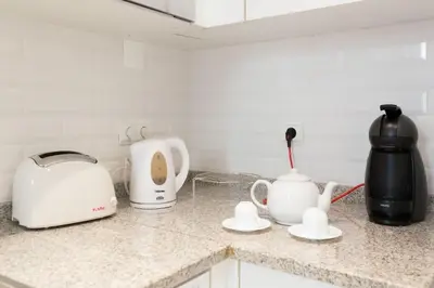 a kitchen counter with a toaster and a tea kettle at Casa Primavera - renovated duplex in city centre in Funchal