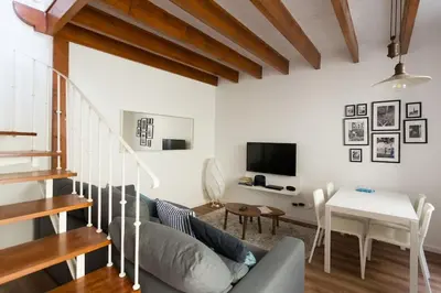 a living room with a couch and a table at Casa Primavera - renovated duplex in city centre in Funchal