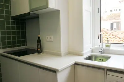 a kitchen with a bottle of wine sitting on a counter at Apartment Primavera: City centre, modern w/balcony in Funchal