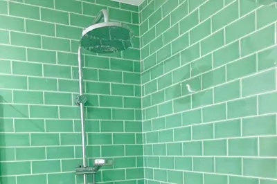a green tiled wall with a shower in a bathroom at Apartment Primavera: City centre, modern w/balcony in Funchal