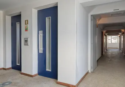 a hallway with blue doors in a building at Blue Wave, a Home in Madeira in Funchal