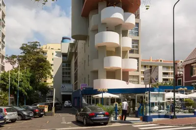 a building with white balconies on a city street at Apartment Banana Panorama: central Lido area in Funchal
