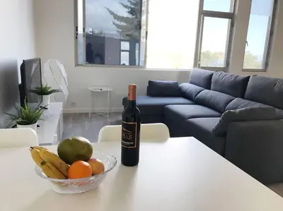 a bottle of wine sitting on a table with a bowl of fruit at Apartment Banana Panorama: central Lido area in Funchal