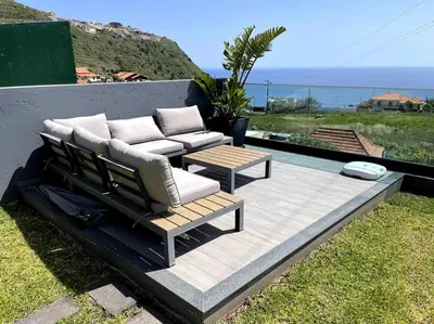 a patio with two couches and a table at Panoramic View: Lux 3 bed with heated pool in Arco da Calheta