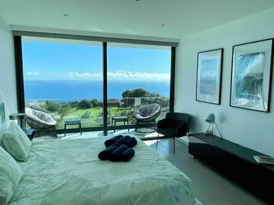 a bedroom with a bed with a view of the ocean at Panoramic View: Lux 3 bed with heated pool in Arco da Calheta