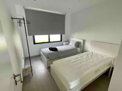 a small bedroom with two beds and a window at Panoramic View: Lux 3 bed with heated pool in Arco da Calheta