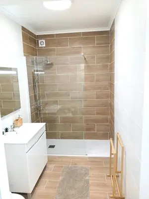a room with a table and a white wall at SandyBeachApartment in Porto Santo