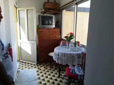 a small room with a table with a television and a dresser at Casa Zona Velha - Caetano in Funchal
