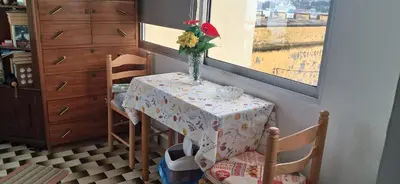 a table with a vase of flowers on it at Casa Zona Velha - Caetano in Funchal