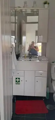 a person taking a picture in a bathroom mirror at Casa Zona Velha - Caetano in Funchal