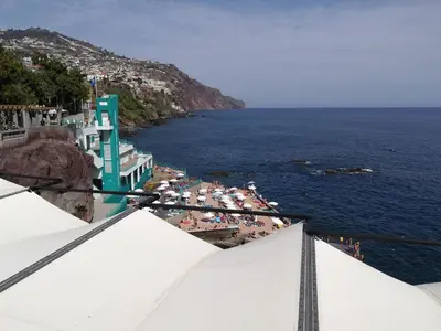 a view of the ocean and a beach with people at Casa Zona Velha - Caetano in Funchal