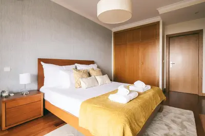 a bedroom with a bed with towels on it at By the Sea II - calmo com piscina e vista mar. in Funchal