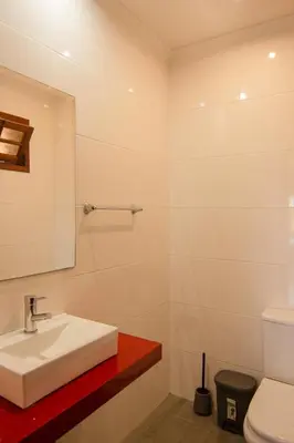 a bathroom with a sink and a mirror and a toilet at Pilar House in Funchal