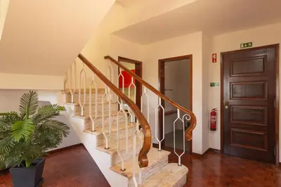 a staircase in a home with a wooden door at Pilar House in Funchal